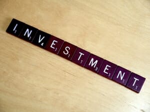 Scrabble tiles spelling out 'investment'